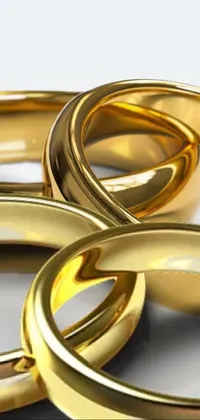 This phone live wallpaper depicts two golden wedding rings resting on a pristine white surface, rendered digitally with hyper-realistic precision