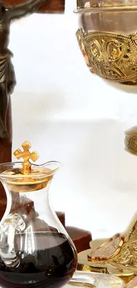 This exquisite live wallpaper for your phone features a baroque-inspired table set with a golden chalice, a holy cross, a set photo, liquids in crystal decanters, and candles