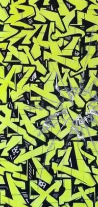 This vibrant live wallpaper features eye-catching yellow and black graffiti art on a wall
