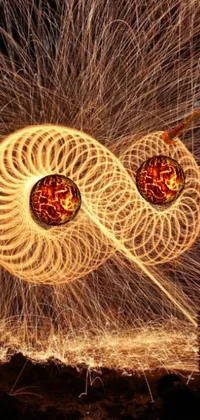 Get mesmerized by this digital live wallpaper featuring spinning balls with intricate fire designs