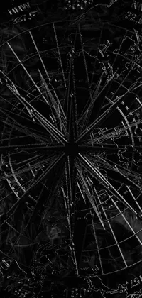 This phone live wallpaper offers a range of visually-stunning options including a black and white photo of a ferris wheel, abstract drawings, digital art, spiderwebs, abstract black hole in space, and a runic etching