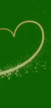 This stunning phone live wallpaper features a heart on a green background with delicate flecks of pixie dust