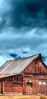 Looking for a rustic live wallpaper with an old west cabin vibe? Check out this stunning digital art of a barn in the middle of a field under a cloudy sky