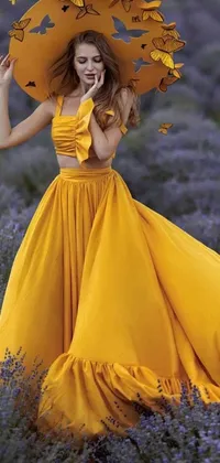 Introducing a stunning phone live wallpaper featuring a female figure in a yellow dress holding a yellow umbrella, set amidst a beautiful field of lavender flowers