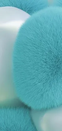 This vibrant phone live wallpaper features a pile of blue pom poms topping a white bowl