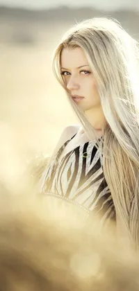 This live wallpaper features a stunning woman with long blonde hair standing in a peaceful field