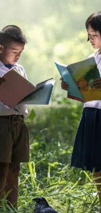 Looking for a calming live wallpaper for your phone? Check out this serene scene of two children engrossed in a book, set in a field of grass