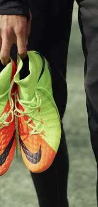 This phone live wallpaper showcases a pair of orange and green shoes that represent energy and power