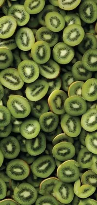 This phone live wallpaper features a delectable stack of kiwi slices in shades of olive green created by Tadashi Nakayama