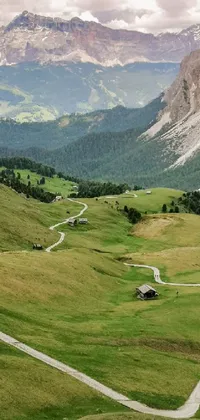 This live wallpaper depicts a winding road through a green valley with mountains in the background