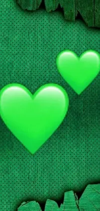 This live wallpaper for your phone features two green hearts on a lively green backdrop inspired by an album cover design in the vein of computer art
