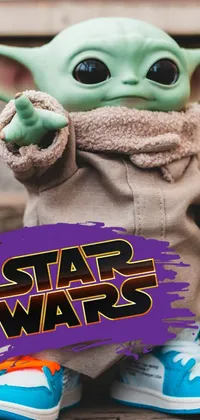 This stunning phone live wallpaper features a close-up of an adorable stuffed Baby Yoda toy with a playful, expressive expression