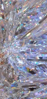Get mesmerized by this live phone wallpaper featuring a stunning collection of crystals sitting on a table