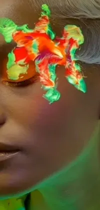 This phone live wallpaper captures a stunning close-up of a person with intricate face paint inspired by David LaChapelle's artwork