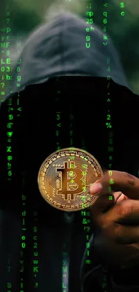 This live phone wallpaper features a dark and ominous theme with a person in a hoodie holding a bitcoin