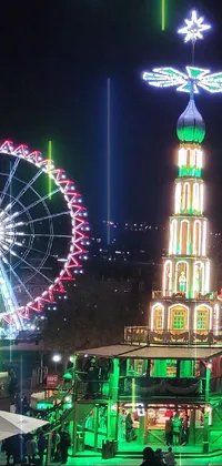 This mobile live wallpaper features a group of people walking in a brightly lit street beside an illuminated ferris wheel