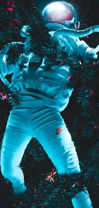This phone live wallpaper showcases an astronaut floating in front of a Christmas tree amidst epic cold blue lighting with an infrared touch