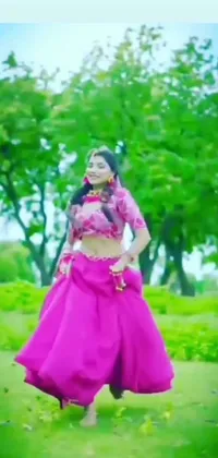 Get mesmerized by this beautiful live wallpaper featuring a graceful woman in a vibrant pink dress, dancing amidst a field filled with colorful flowers