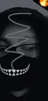 This phone live wallpaper features a person wearing a face mask inspired by some of the latest online trends, such as Tumblr, graffiti, pointed teeth, and several eyes