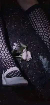 This live wallpaper features a bold close-up of a person wearing fishnet stockings