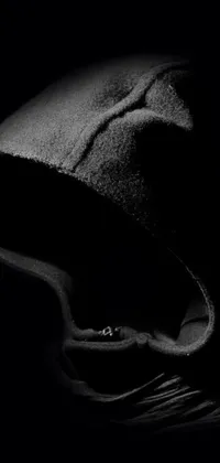 This unique phone live wallpaper features a close-up shot of an individual wearing a hoodie