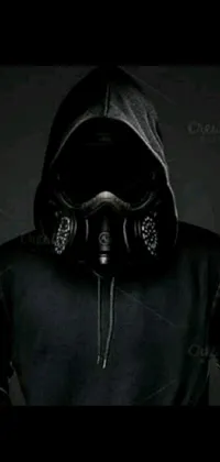 This live wallpaper boasts a dark and mysterious figure cloaked in black, wearing a haunting gas mask