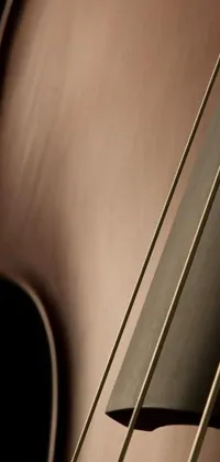 This phone live wallpaper features a close-up shot of the strings of a cello