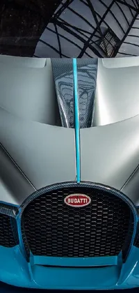 This phone live wallpaper features a captivating close-up view of a luxurious Chiron car against a deep blue background
