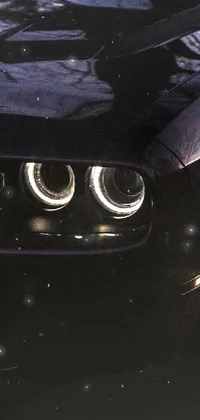 This live phone wallpaper features close-up shots of car headlights with intricate details and textures