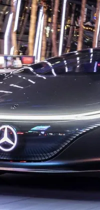 This phone live wallpaper features a Mercedes Benz car driving down a futuristic city street at night, surrounded by mesmerizing hologram technology