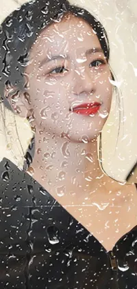 This live phone wallpaper features a striking depiction of a woman standing under an umbrella in the rain