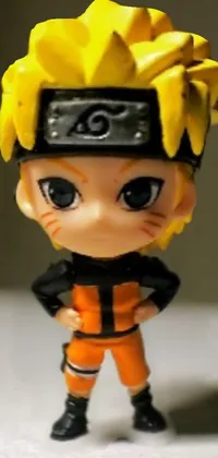 Looking for a unique and eye-catching phone wallpaper? Look no further than this close-up of a charming figurine in chibi proportions! Featuring Naruto Uzumaki, a popular anime character, this live wallpaper exudes cuteness and charm