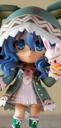 This phone live wallpaper showcases a cute Kamagurka toy dressed in a bunny suit on a wooden table