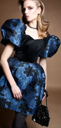 This phone live wallpaper showcases a fashionable woman donning a voluminous blue and black dress