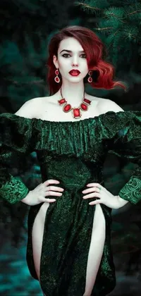 This phone live wallpaper showcases a striking female figure with fiery red locks, dressed in a glamorous green gown