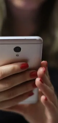 This mobile live wallpaper showcases a lifelike portrayal of a person holding and checking a cell phone