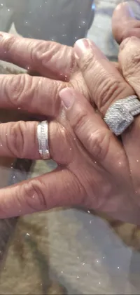 Get a stunningly realistic live wallpaper for your phone featuring a close-up of a hand with a diamond ring