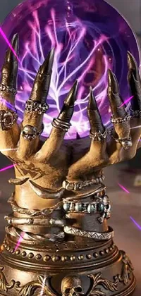 This phone live wallpaper features a mystical purple crystal ball with steampunk hands that are holding it