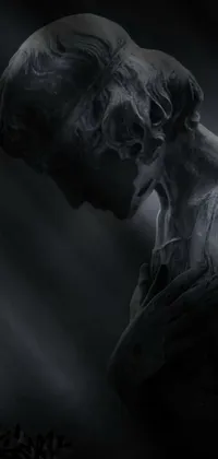 This phone live wallpaper displays a stunning black and white photograph of a weeping statue, set against a lovecraftian background