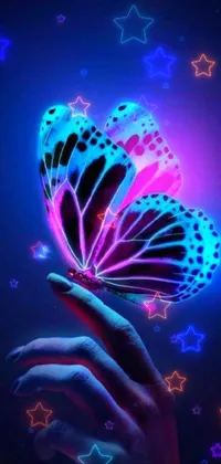 This stunning mobile wallpaper portrays a magical experience with a glowing butterfly held in a hand
