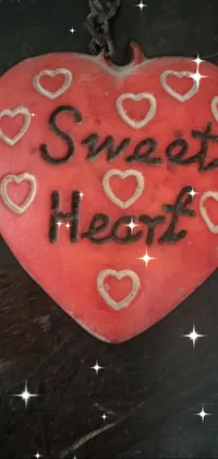 This phone live wallpaper features a glowing red heart with the words "Sweet Heart" scripted on it