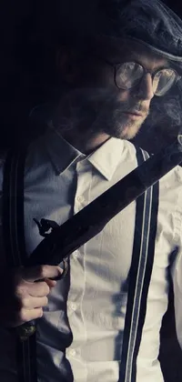 The phone live wallpaper showcases an elegant man sporting a classic outfit of a hat and suspenders, while smoking a cigarette