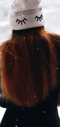 This phone live wallpaper is a stunning digital art depicting a woman with long red hair standing in the snow