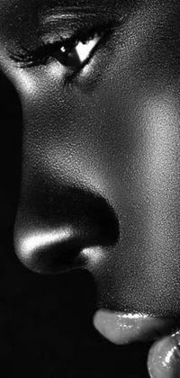 This live phone wallpaper showcases a stunning black and white metallic sculpture of a woman's features