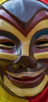 This phone live wallpaper showcases a close-up of a clown mask in vibrant red and yellow clothing