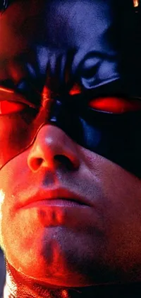 The phone live wallpaper displays a close-up shot of a Batman mask with a cobra-like design on the face