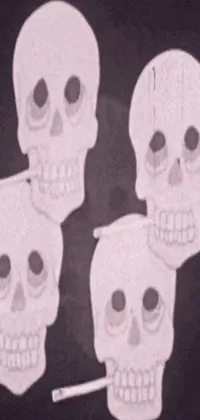 This live phone wallpaper features a group of skulls arranged side-by-side against a Tumblr-inspired background