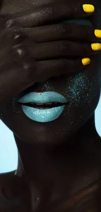 This phone live wallpaper showcases a woman with yellow nails covering her eyes against a turquoise blue background