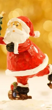 This live wallpaper features a lively figurine of Santa Claus holding a Christmas tree
