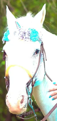 This stunning phone live wallpaper features a beautiful white horse with blue flowers on its head, captured in a close-up image that highlights its elegance and grace